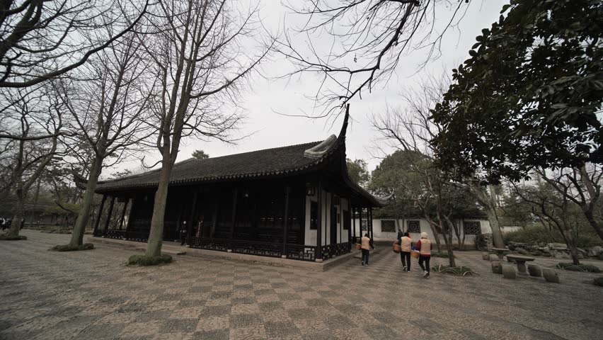 Walking through the ancient architecture and rockery landscapes of Suzhou Gardens in China.