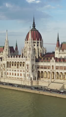 Aerial around view of Budapest city and Hungarian Parliament building on Danube river, Hungary. Vertical video