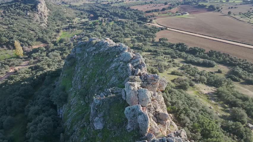 Orbital flight over an impressive natural limestone rock structure, we start on the side where the sun is projected and has a great variety of beautiful colors, we appreciate its surroundings
