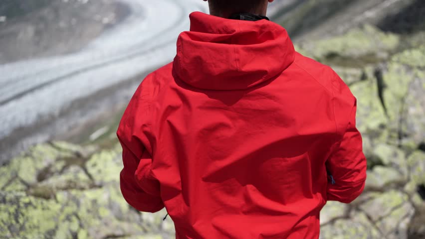 Man in red jacket with drone glasses overlooking Norway