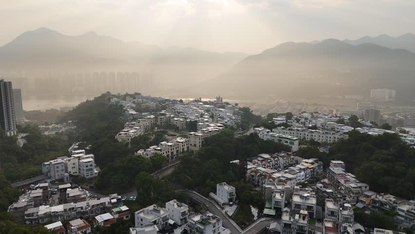 Beautiful aerial clip of Kau To Shan and Kau To village in the New Territories, Hong Kong, on a sunny misty morning.