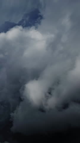 Lot of lightning during a thunderstorm. Storm clouds are moving fast on the viewer, timelapse. Vertical video