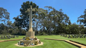 ANZAC War Memorial cross monument flower wreaths lawn gum trees Nedlands Perth WA - Powered by Shutterstock - Get 15% off with code: PIKWIZARD15