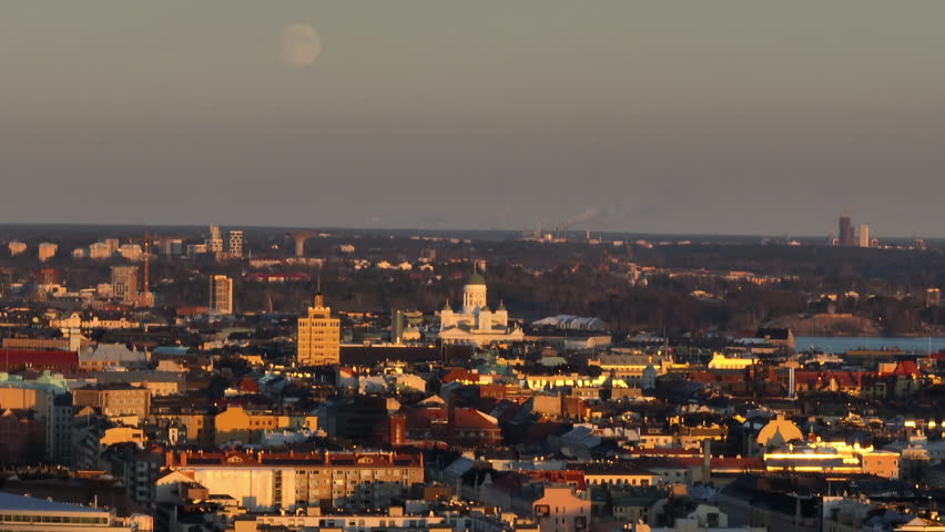 Aerial view around the cathedral and the city, sunset with the moon in Helsinki