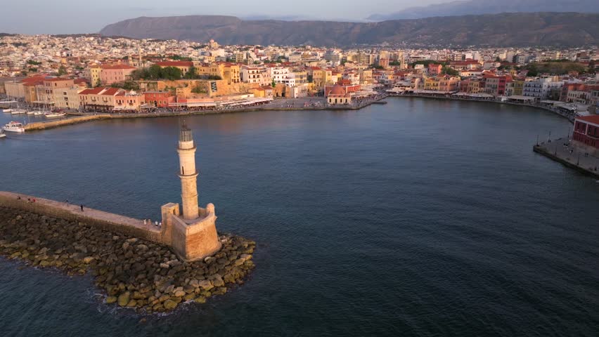 Chania town by night, Lighthouse, Drone shot, Crete, Greece, Aerial view of Chania with the amazing lighthouse, Beautiful Old city, Greece and best scenic places - panorama of picturesque old town 