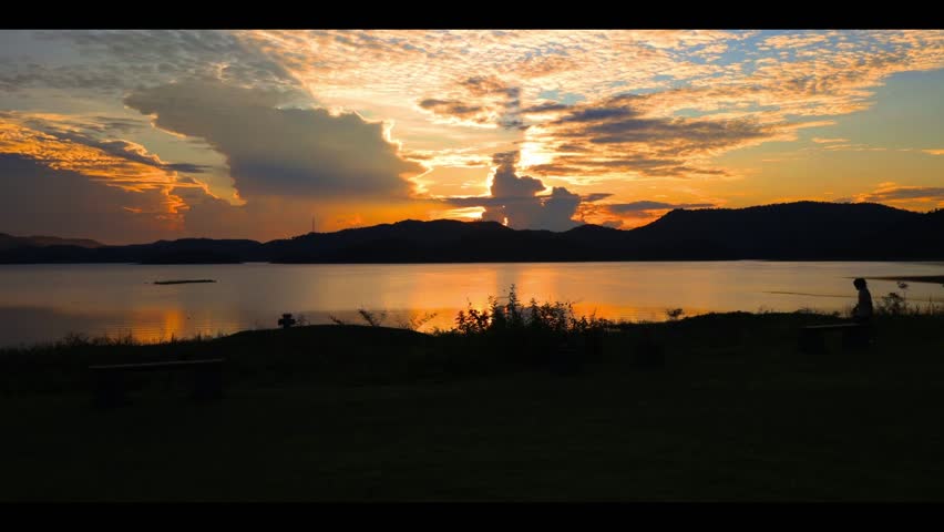 Timelapse Sunrise on the lake and mountains and people taking photos of the beauty