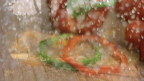 Sliced red and green bell peppers with water splashes on wooden surface. Vegetables, freshness, cooking, culinary, clean eating, healthy lifestyle - Powered by Shutterstock - Get 15% off with code: PIKWIZARD15