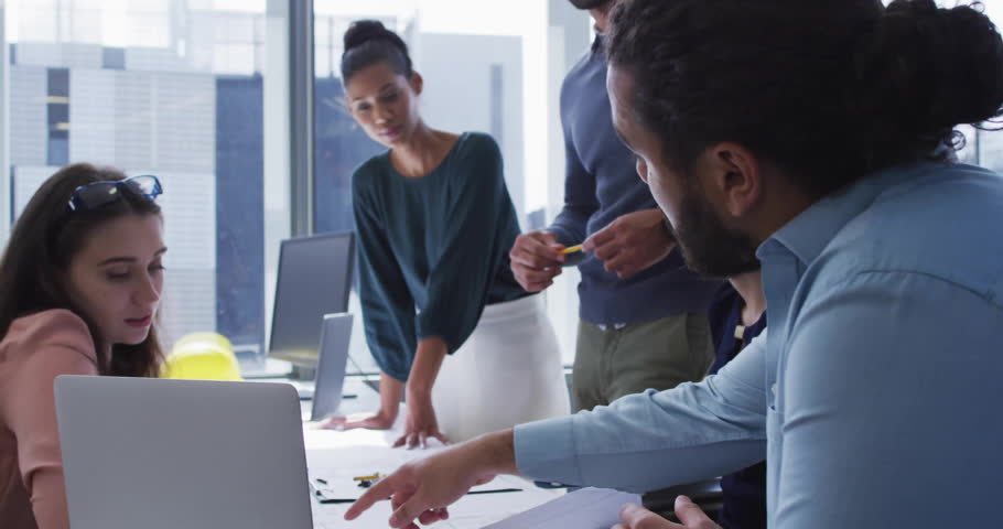 Collaborating in office, diverse team engaging with social media notifications. Teamwork, collaboration, diversity, communication, technology, digital