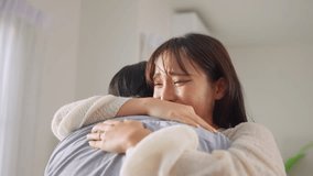 Asian romantic man surprise his girlfriend with a marriage proposal. Young man proposes to his beautiful happy partner with wedding ring, creating joyful moment of engagement in living room at home. - Powered by Shutterstock - Get 15% off with code: PIKWIZARD15