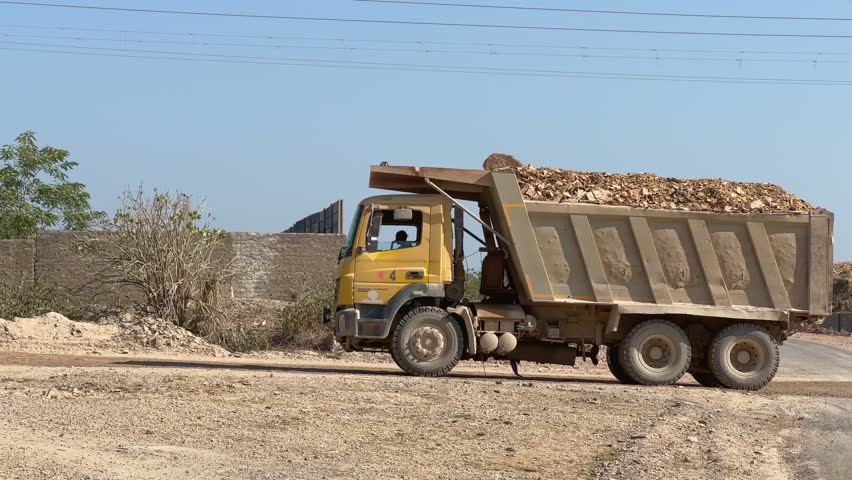 A truck load of iron ore or raw material being carried away on Hyva trucks, these hyva used in a variety of industries, including construction, mining, transportation, and agriculture.