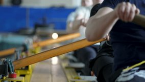 Water sports rowing simulator. Close up rowing team hands work with paddles, preparing for competitions. Arms make circular motions developing flexibility stability, muscle memory and concentration - Powered by Shutterstock - Get 15% off with code: PIKWIZARD15