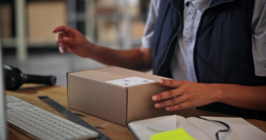 Scanner, label and person with box in warehouse for distribution stock, sticker and address. Hands, factory or logistics worker in small business for order, packaging process and ecommerce parcel