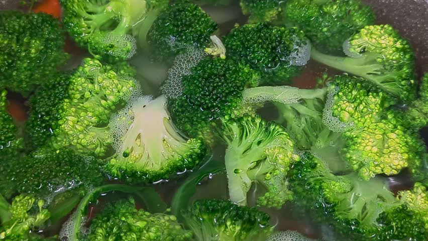 Top view fresh green broccoli being boiled in water. 