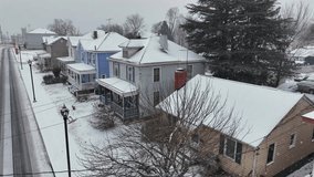 Snowfall in small american neighborhood during Christmas time. Aerial static shot. Snowy roofs and slushy road in USA. Colonial and Victorian houses with porch. Virginia, America. Wide shot. - Powered by Shutterstock - Get 15% off with code: PIKWIZARD15