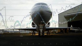 Financial graph animation overlaying airplane on tarmac at airport runway. Aviation, finance, economy, investment, transportation, travel - Powered by Shutterstock - Get 15% off with code: PIKWIZARD15