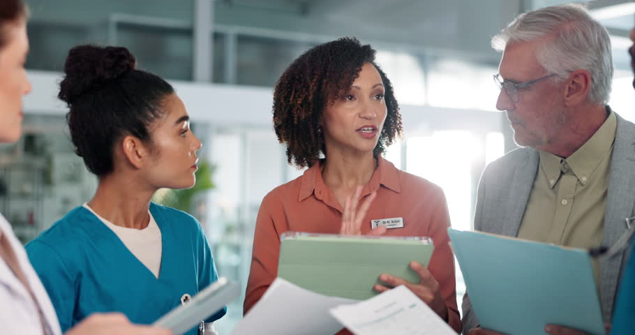 Doctors, woman and group with tablet in hallway with leader, report and documents for medical solution. People, discussion and listen with team, paperwork or planning strategy for funding at hospital