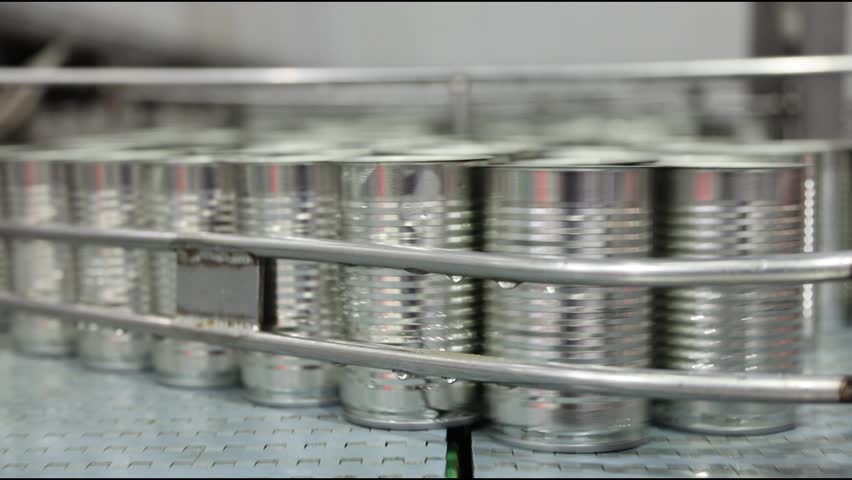 Tin can speed travel in convey belt transport in for food container in production line at food manufacturing process, Fish canned factory.
