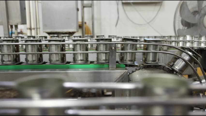 Tin can speed travel in convey belt transport in for food container in production line at food manufacturing process, Fish canned factory.