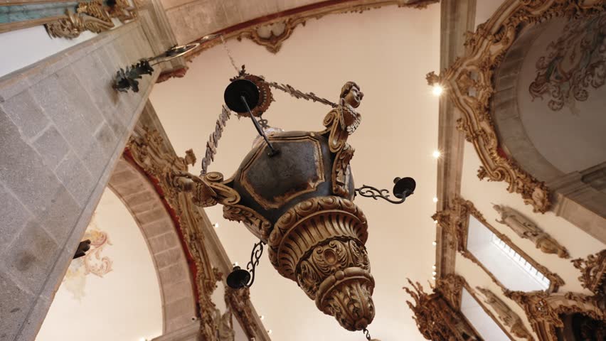 Ornate hanging censer with intricate gold details inside a historic church in Braga, Portugal