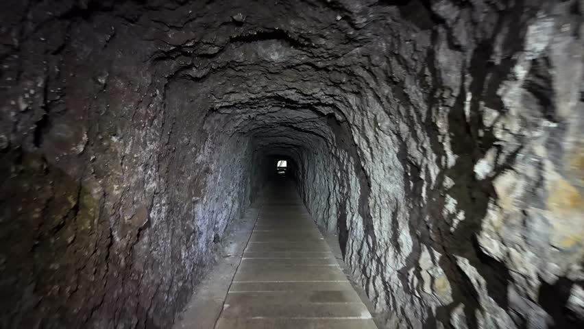 Hiking Through a Dark Tunnel on PR16 Levada Faja do Rodrigues, Emerging into the Light, Madeira, Portugal