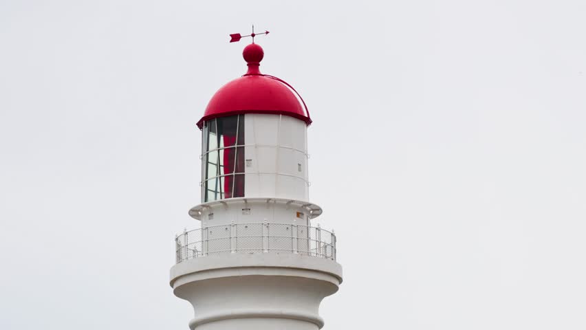 A serene timelapse of Split Point Lighthouse against a cloudy sky, showcasing subtle changes in lighting and perspective