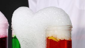 A vibrant science experiment with dry ice creating bubbling foam in colorful liquids, showcasing chemical reactions - Powered by Shutterstock - Get 15% off with code: PIKWIZARD15