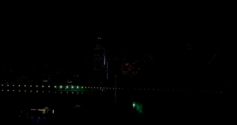 Footage overlooking the old town of Benidorm in Spain showing fireworks at night on the beach front with the West Beach Promenade in the background celebrating a Spanish festival at night time