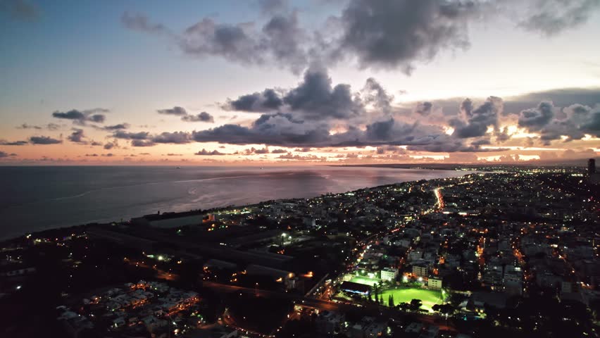 Aerial Coastal Cityscape Pan View over Santo Domingo at Sunset