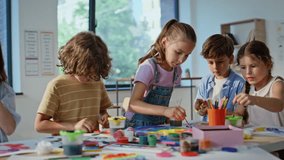 Kids engaged in art activity at elementary school artclass closeup. Group children focused on creativity working with colorful materials in classroom. Creative pupils making handmade crafts together. - Powered by Shutterstock - Get 15% off with code: PIKWIZARD15
