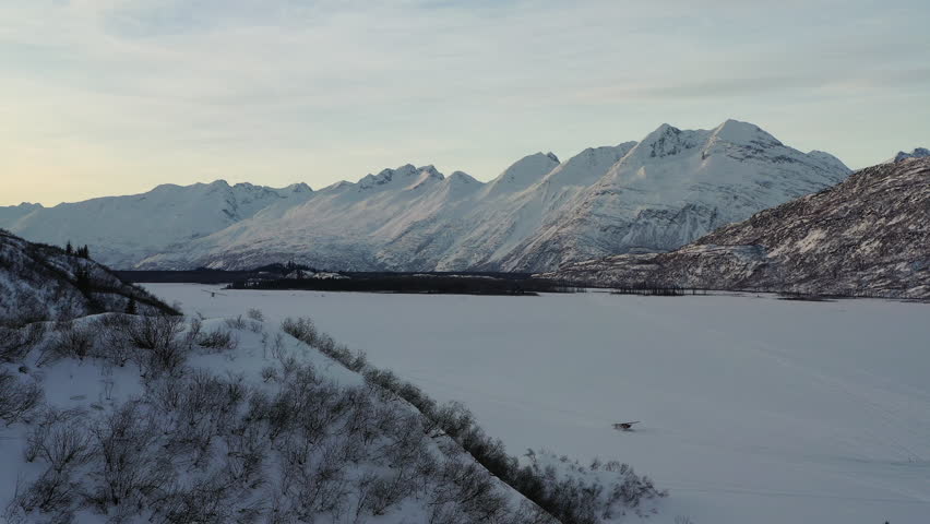Aerial view of a breathtaking snowy mountain landscape in Chugach State and National Park, Anchorage, Alaska, United States.