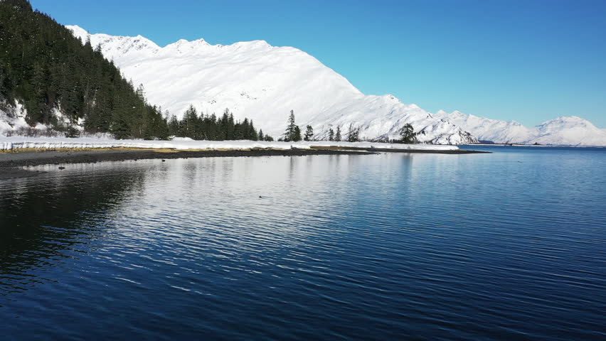 Aerial view of serene and picturesque Chugach State and National Park with majestic mountains, tranquil lake, and lush forest, Anchorage, Alaska, United States.