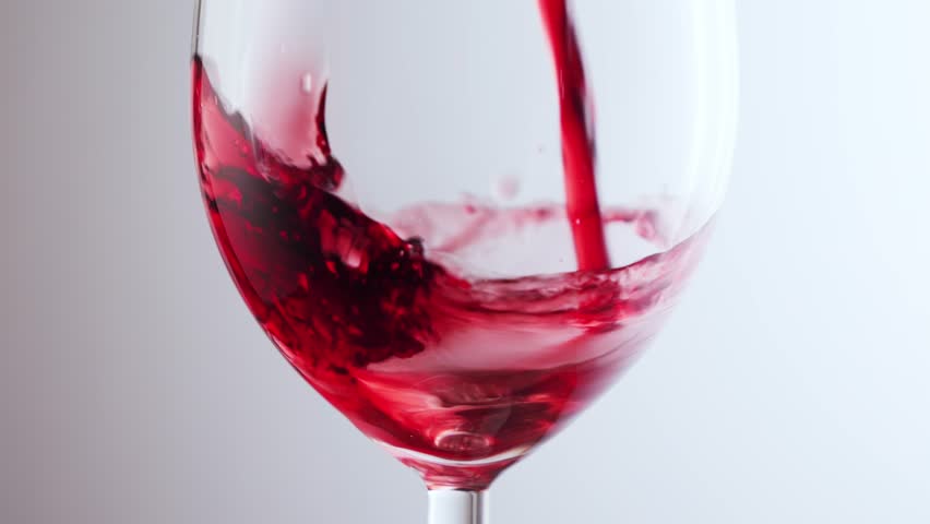 Pouring red wine into glass close-up. High quality 4k footage