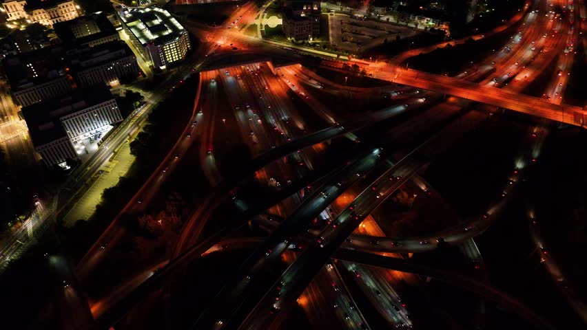 Aerial view of busy highway interchange with vibrant city lights and traffic, downtown Atlanta, Georgia, United States.
