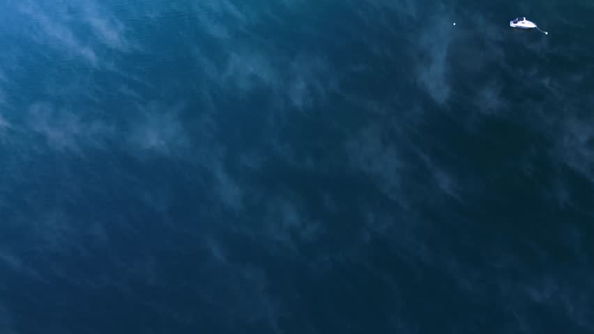 Aerial view of serene Grand Teton landscape with snowy mountains, tranquil forest, and peaceful lake at sunrise, Jackson, Wyoming, United States.