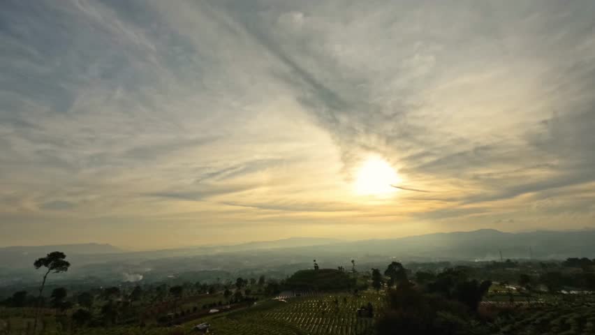 Timelapse of sunset from evening until the sun disappears on the horizon. View of the city from the mountains. Dramatic movement of clouds seen from the mountains. Footage 4K