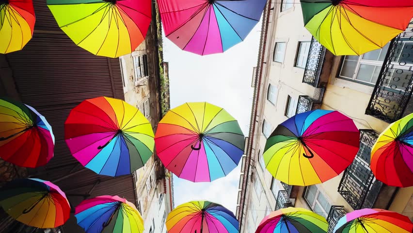 Colorful rainbow umbrellas over the street in Lisbon, Portugal. Famous tourist location
