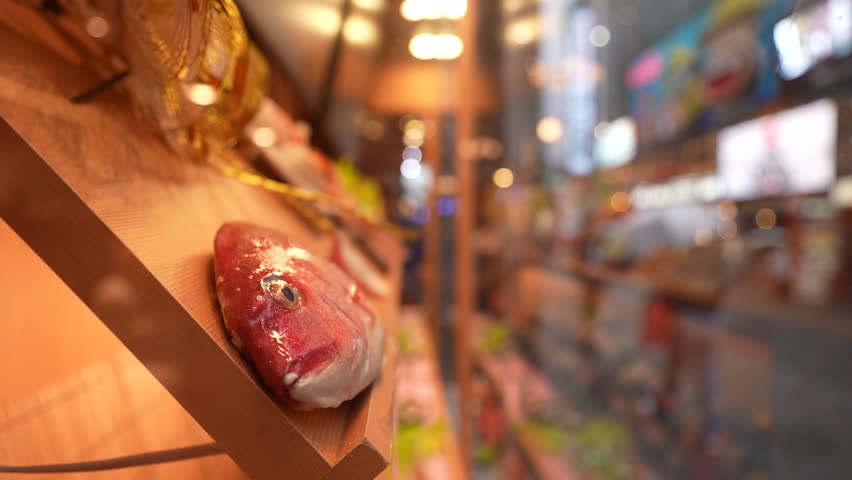 View of menu items in restaurant window in busy Dotonbori, vibrant entertainment district near the river, Osaka, Honshu, Japan