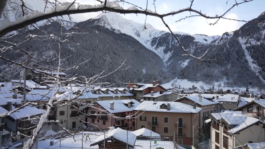 View of snow covered rooftops and mountainous background in winter, Courmayeur, Aosta Valley, Italian Alps, Italy