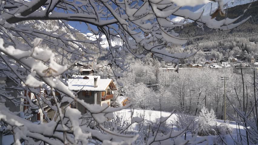 View of snow covered mountain tops and Courmayeur town centre in winter from Dolonne, Courmayeur, Aosta Valley, Italian Alps, Italy