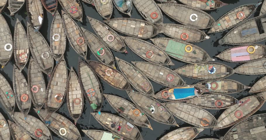 Aerial view of traditional boats on the clear Buriganga river, Dhaka, Bangladesh.