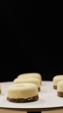 mini cheesecakes or mousse cake rotating on stand