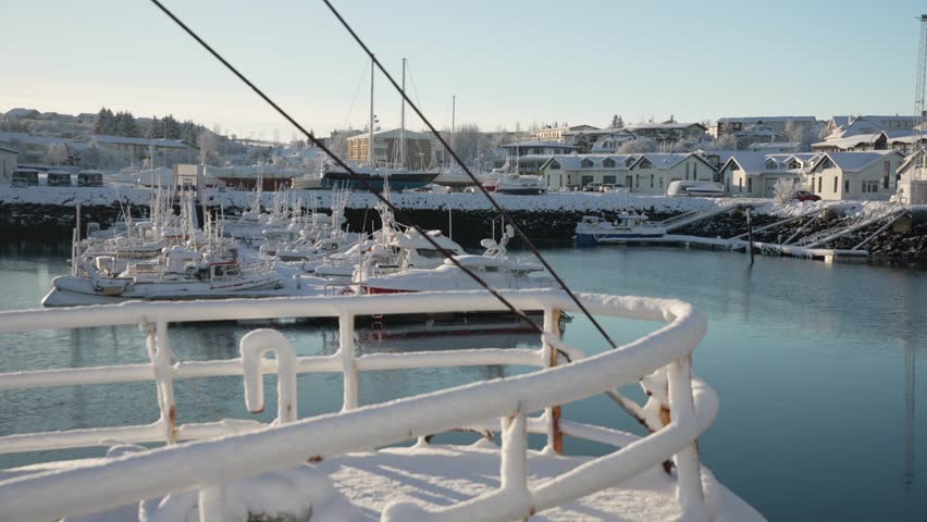 View of snow covered boats in the harbour at Hafnarfjorour in winter, Hafnarfjorour, Reykjavik, Iceland