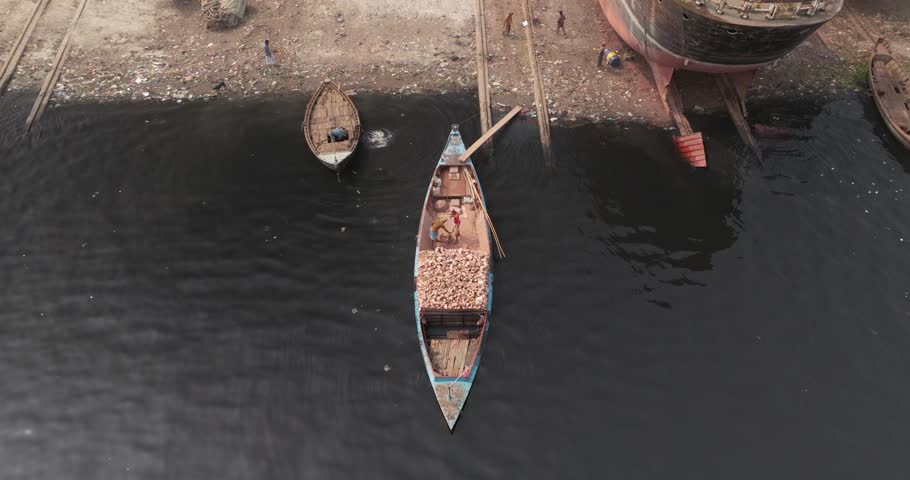 Aerial view of traditional wooden boats on the clear Buriganga river, Sadar Ghat, Dhaka, Bangladesh.