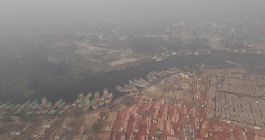 Aerial view of Buriganga river with cement industries and boats in a dense urban landscape, Dhaka, Dhaka Province, Bangladesh.