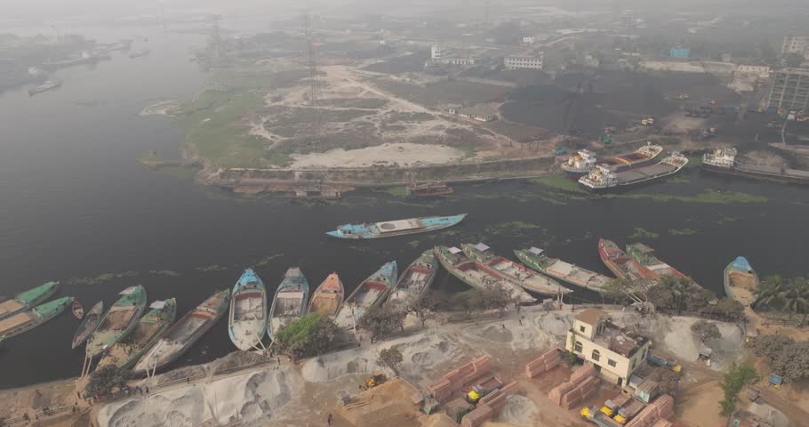 Aerial view of Buriganga river with industrial cement industries and boats, Dhaka, Dhaka Province, Bangladesh.