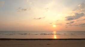 Time lapse of golden sun on sunset sky background over sea with natural light and silhouette people walking on the beach, peaceful nature seaview scene - Powered by Shutterstock - Get 15% off with code: PIKWIZARD15