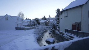View of shop and snow covered houses and stream in Hafnarfjorour in winter, Hafnarfjorour, Reykjavik, Iceland - Powered by Shutterstock - Get 15% off with code: PIKWIZARD15