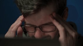 A tired coder wearing eyeglasses working late at night feels a headache and rubs his eyes from fatigue. Overwork concept - Powered by Shutterstock - Get 15% off with code: PIKWIZARD15