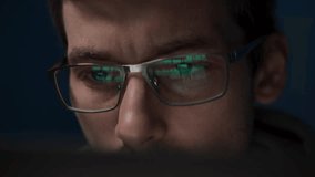 Close-up of a coder in glasses, intently working on a script. The reflection of programming code is visible on his eyeglasses as he develops an application. - Powered by Shutterstock - Get 15% off with code: PIKWIZARD15