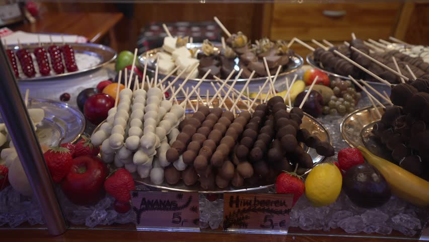 Chocolate covered fruit on Christmas market stall in Rathausstrasse in winter, Mitte, Berlin, Germany